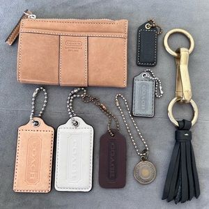 Small coach leather card/coin purse tan. With assorted Coach purse tags/charms